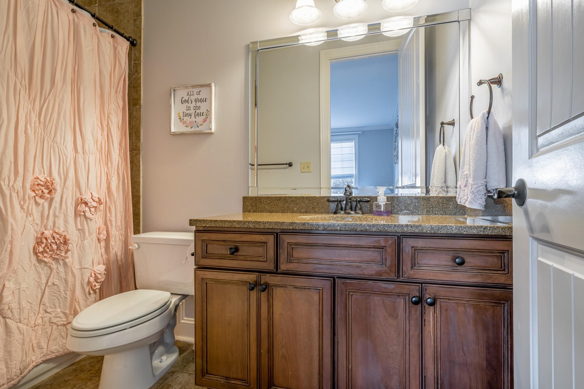 1247 Braywind Drive Collierville, TN 38017 - Photo 15 of 25 a bathroom with a granite countertop toilet sink and mirror