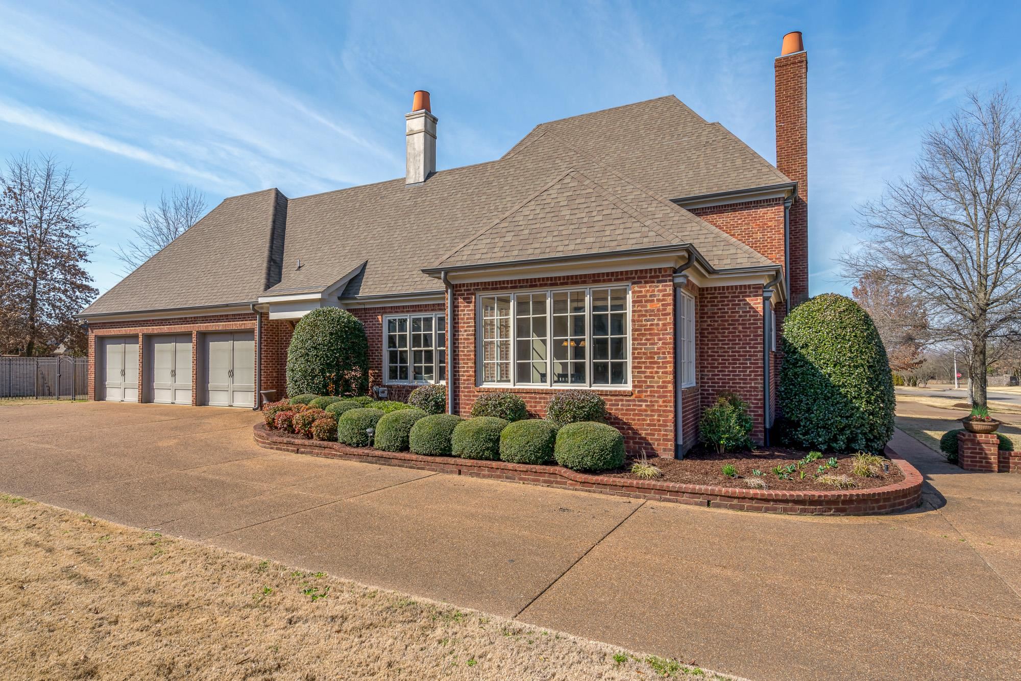 1247 Braywind Drive Collierville, TN 38017 - Photo 24 of 25 a front view of a house with a yard and potted plants
