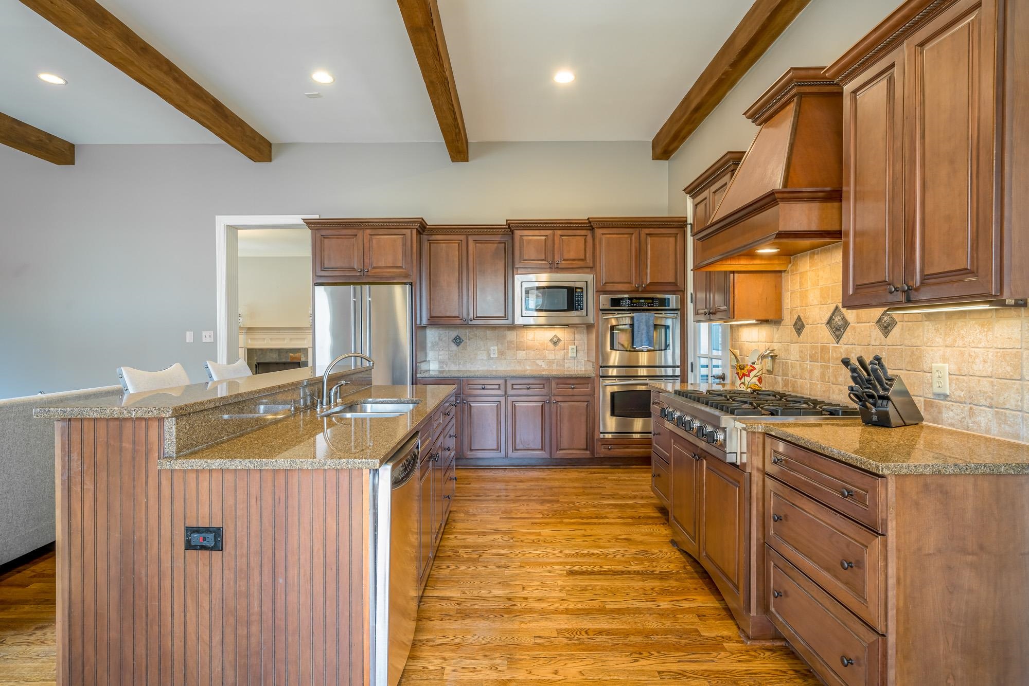 1247 Braywind Drive Collierville, TN 38017 - Photo 8 of 25 a kitchen with stainless steel appliances granite countertop a sink stove and refrigerator