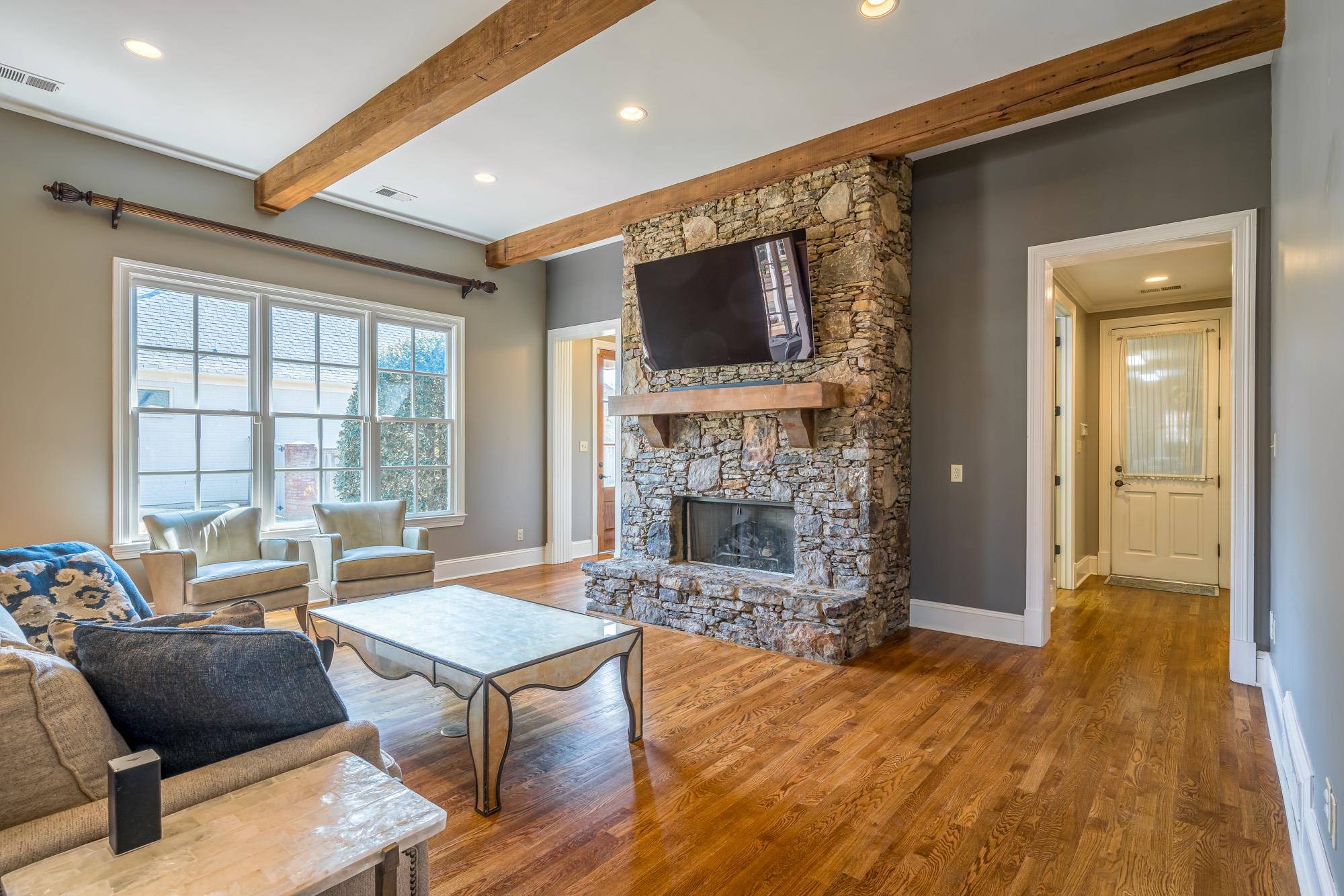 1247 Braywind Drive Collierville, TN 38017 - Photo 10 of 25 a living room with furniture a flat screen tv and a fireplace