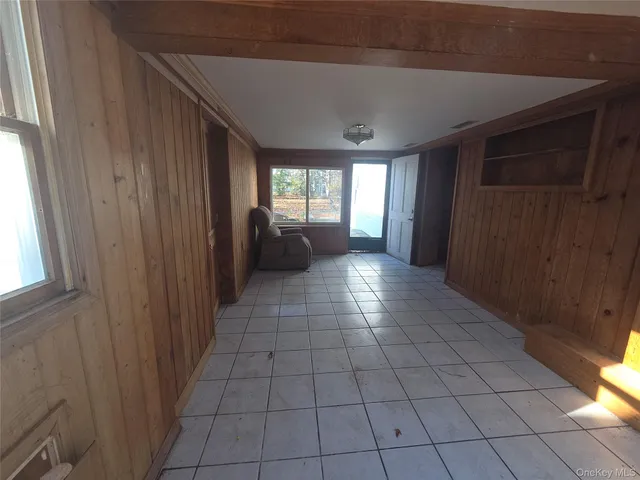 a kitchen with a refrigerator and table chairs