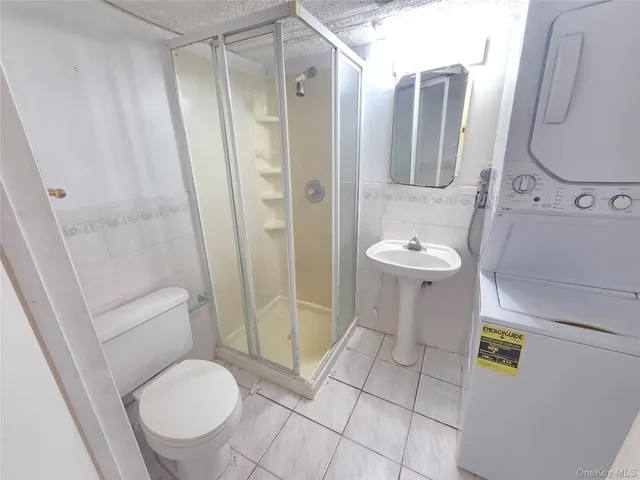 a bathroom with a sink a toilet and a large mirror