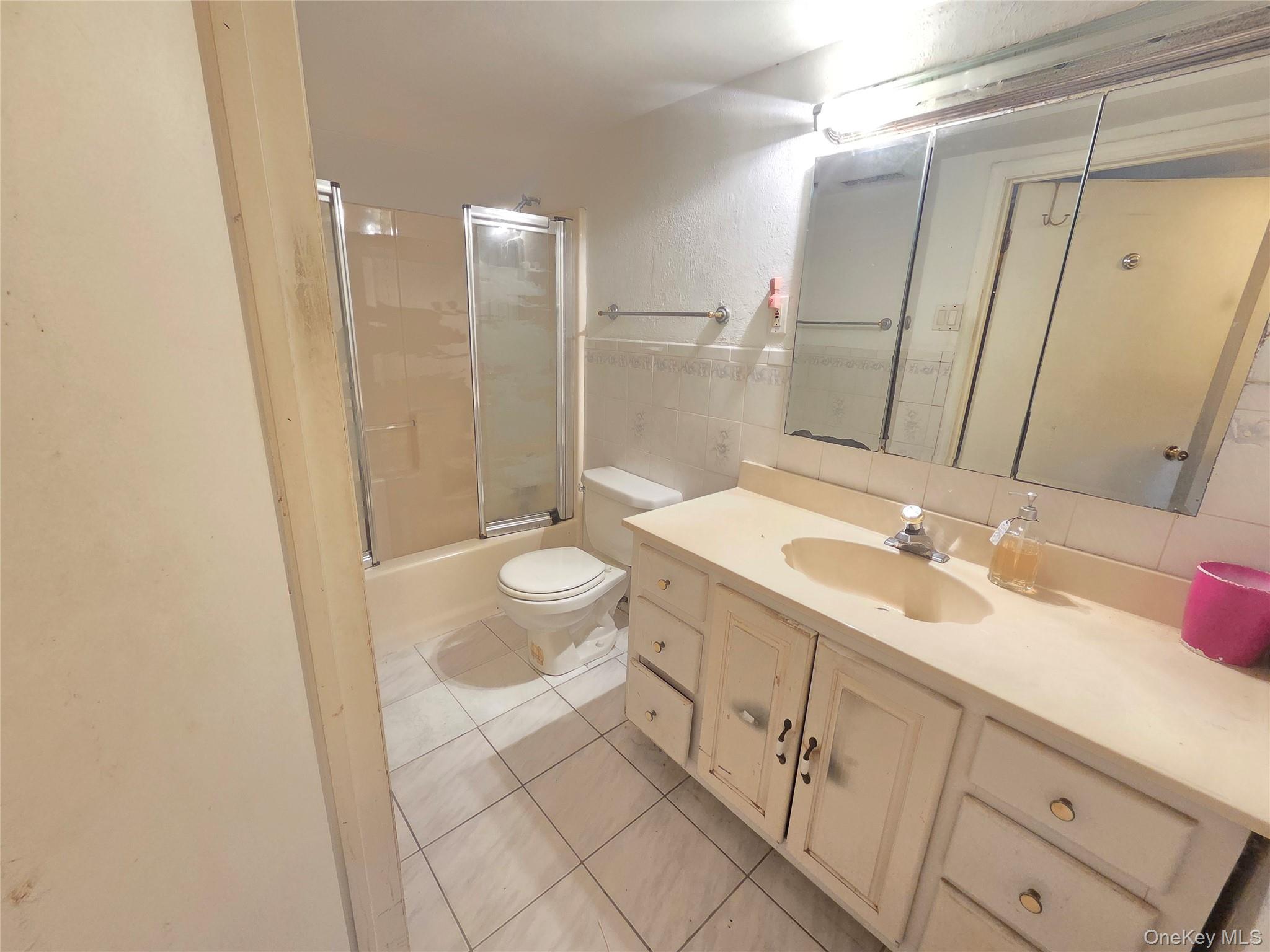 30 Matthews Drive Remsenburg, NY 11960 - Photo 6 of 11 a bathroom with a sink a toilet and a large mirror