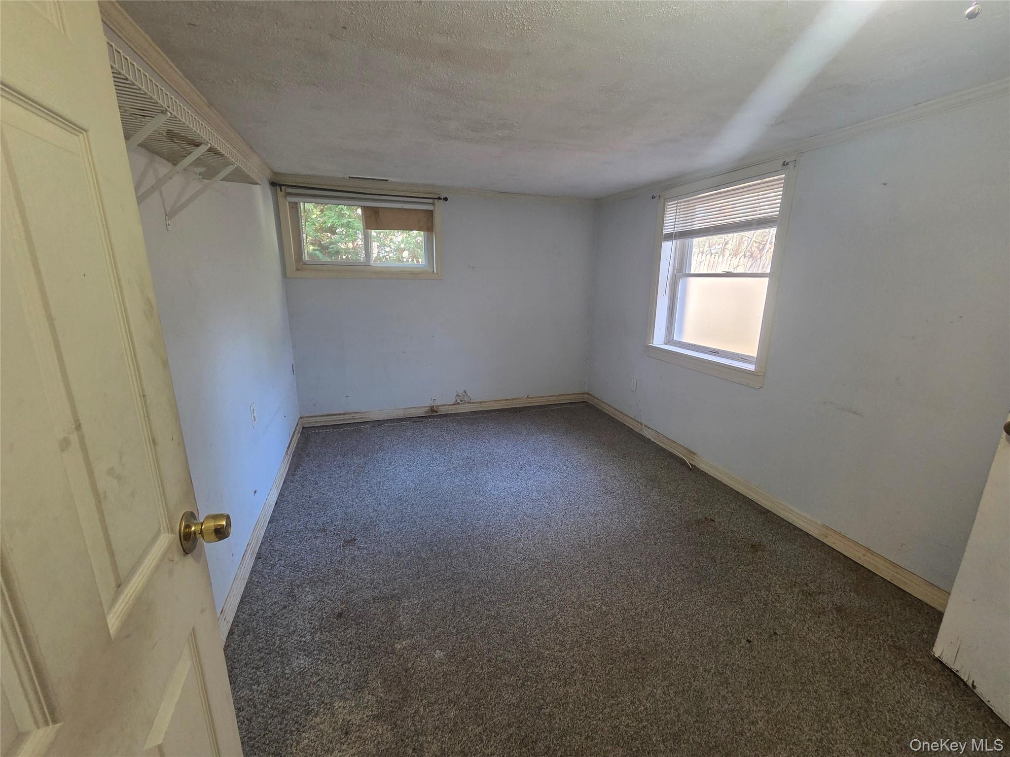 30 Matthews Drive Remsenburg, NY 11960 - Photo 7 of 11 an empty room with windows