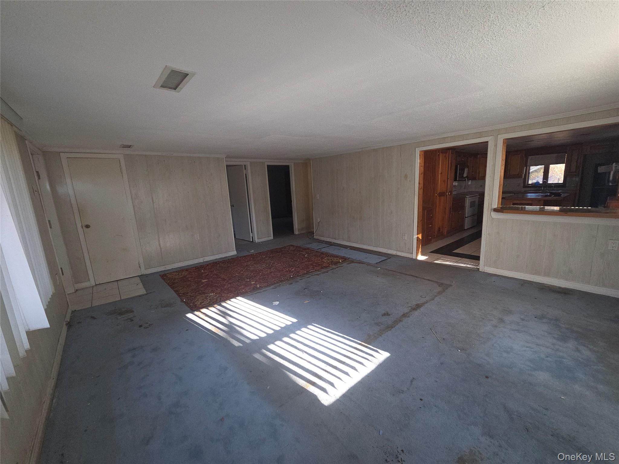 30 Matthews Drive Remsenburg, NY 11960 - Photo 10 of 11 a view of an empty room with glass door and windows