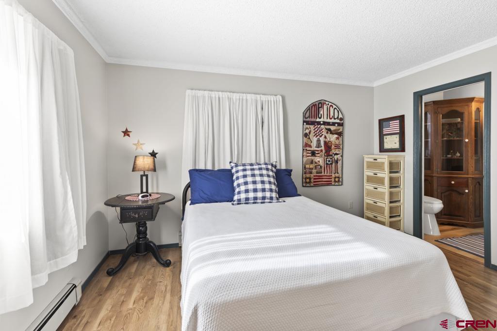 2135 Winston Way, Unit A Montrose, CO 81401 - Photo 12 of 27 a spacious bedroom with a bed and a large mirror on the dresser