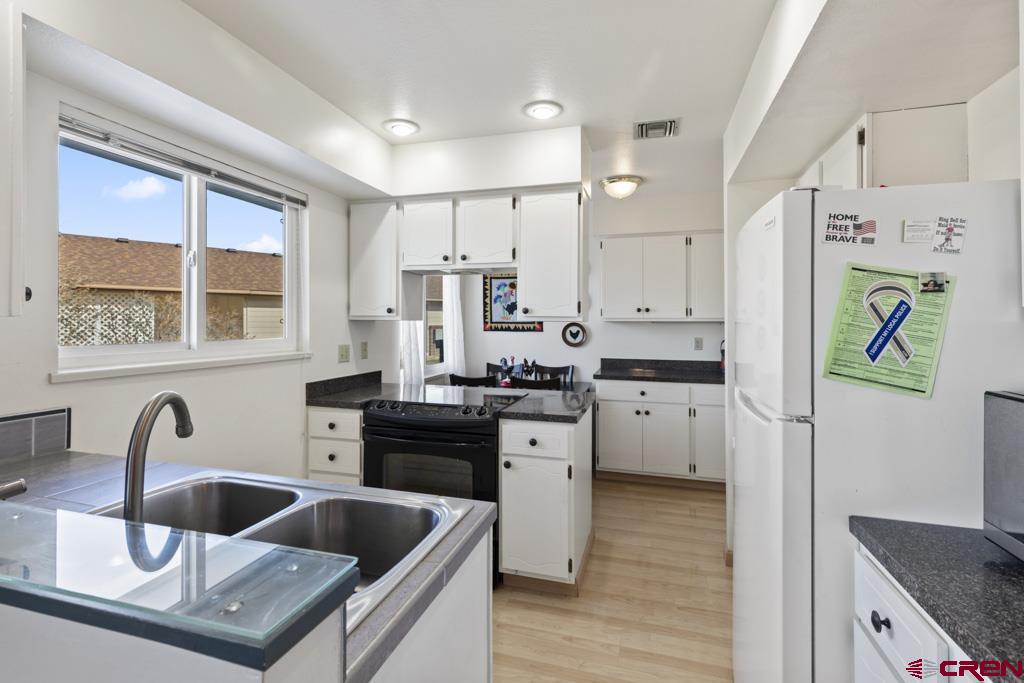 2135 Winston Way, Unit A Montrose, CO 81401 - Photo 18 of 27 a kitchen with granite countertop a sink stainless steel appliances and cabinets