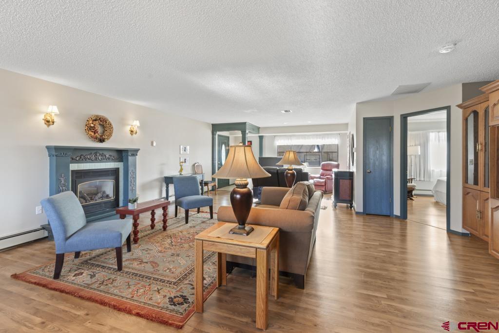 2135 Winston Way, Unit A Montrose, CO 81401 - Photo 20 of 27 a living room with furniture a fireplace and wooden floor