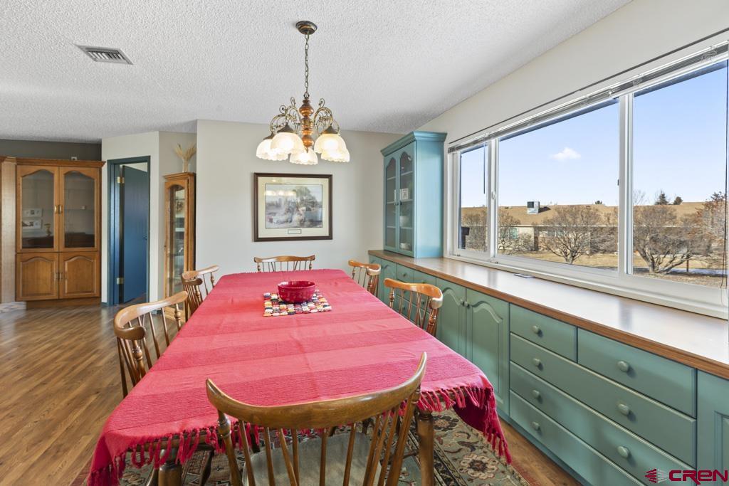 2135 Winston Way, Unit A Montrose, CO 81401 - Photo 22 of 27 a view of a dining room with furniture window and wooden floor