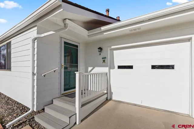 a view of a porch with wooden floor and fence