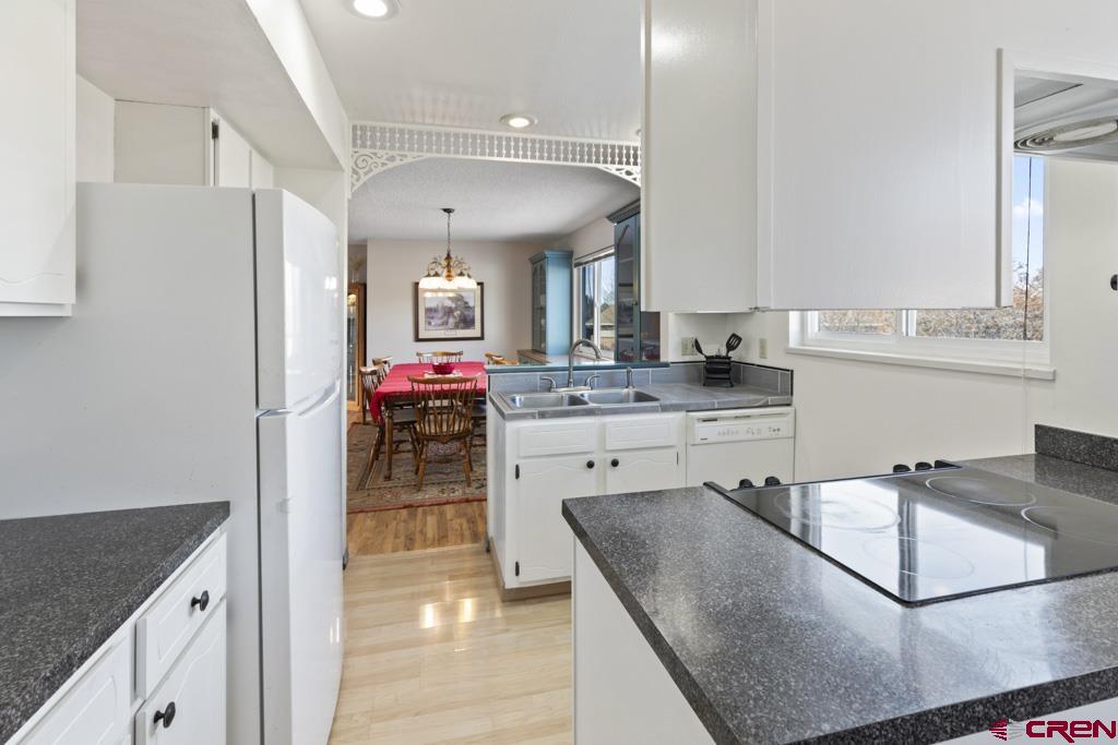 2135 Winston Way, Unit A Montrose, CO 81401 - Photo 3 of 27 a kitchen with kitchen island granite countertop a sink cabinets and stainless steel appliances