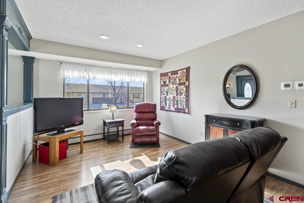 2135 Winston Way, Unit A Montrose, CO 81401 - Photo 6 of 27 a living room with furniture a flat screen tv and a large window