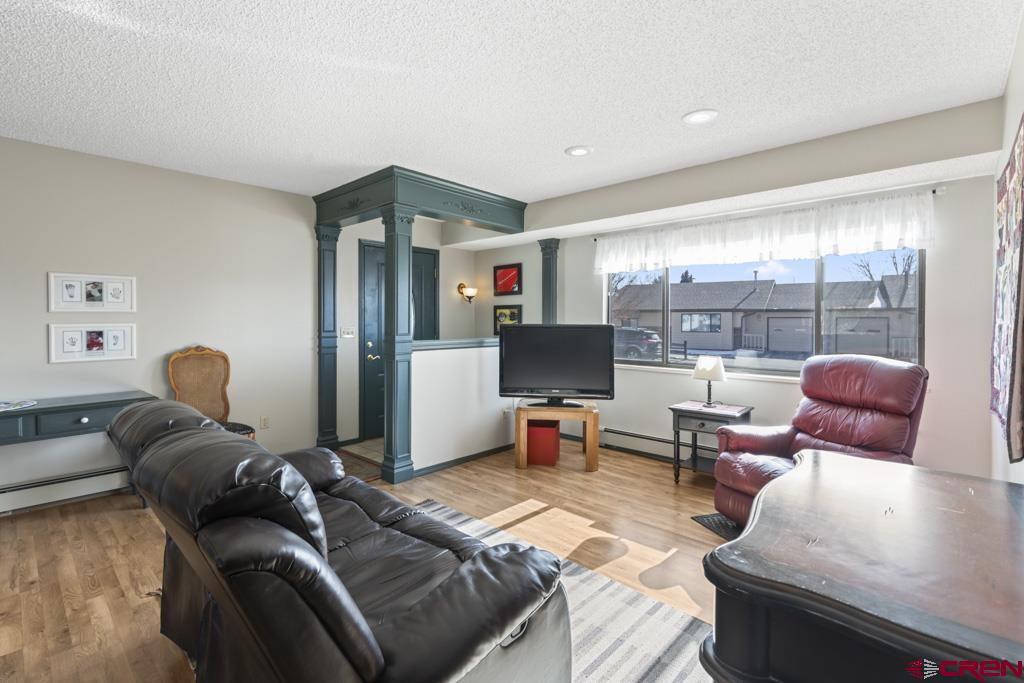 2135 Winston Way, Unit A Montrose, CO 81401 - Photo 7 of 27 a living room with furniture and a flat screen tv