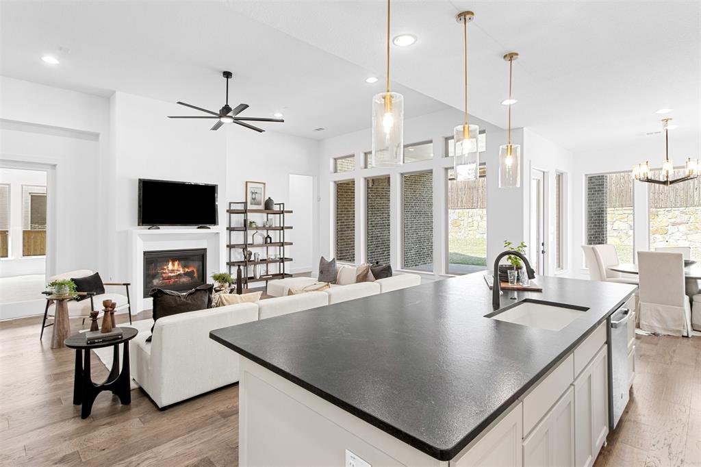 2808 Citation Road Celina, TX 75009 - Photo 12 of 40 a kitchen with a kitchen island a sink dining table and chairs