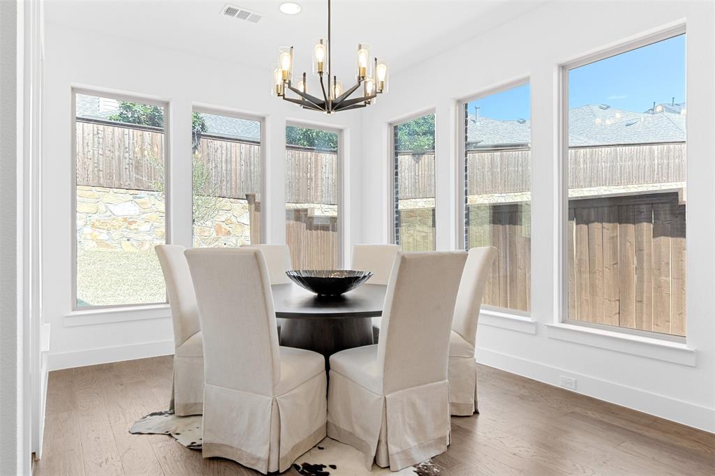 2808 Citation Road Celina, TX 75009 - Photo 13 of 40 a dining room with furniture a chandelier and wooden floor