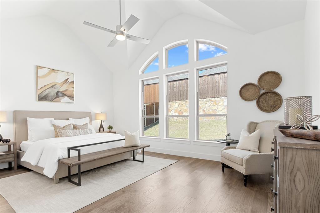 2808 Citation Road Celina, TX 75009 - Photo 14 of 40 a spacious bedroom with a bed couch and window