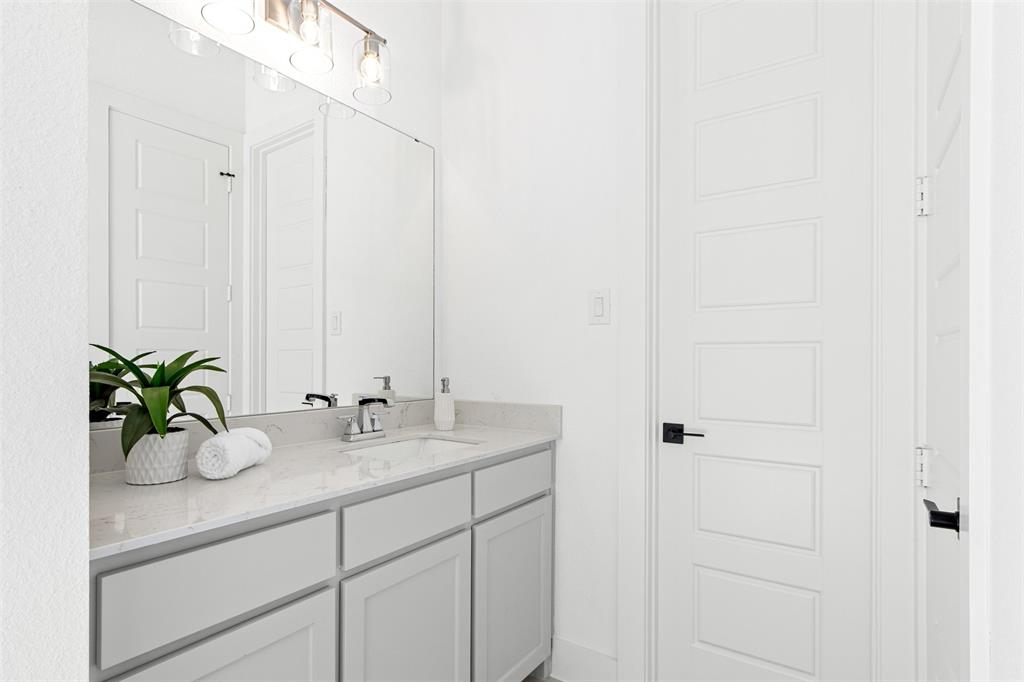 2808 Citation Road Celina, TX 75009 - Photo 24 of 40 a bathroom with a granite countertop sink and a mirror