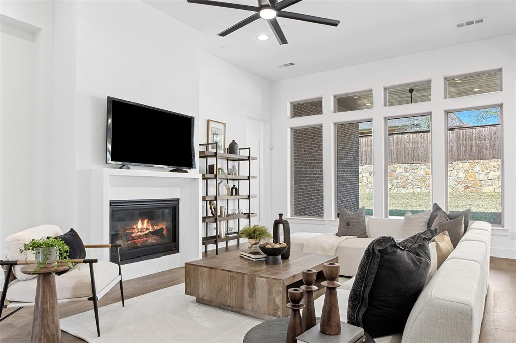2808 Citation Road Celina, TX 75009 - Photo 6 of 40 a living room with furniture a fireplace and a flat screen tv