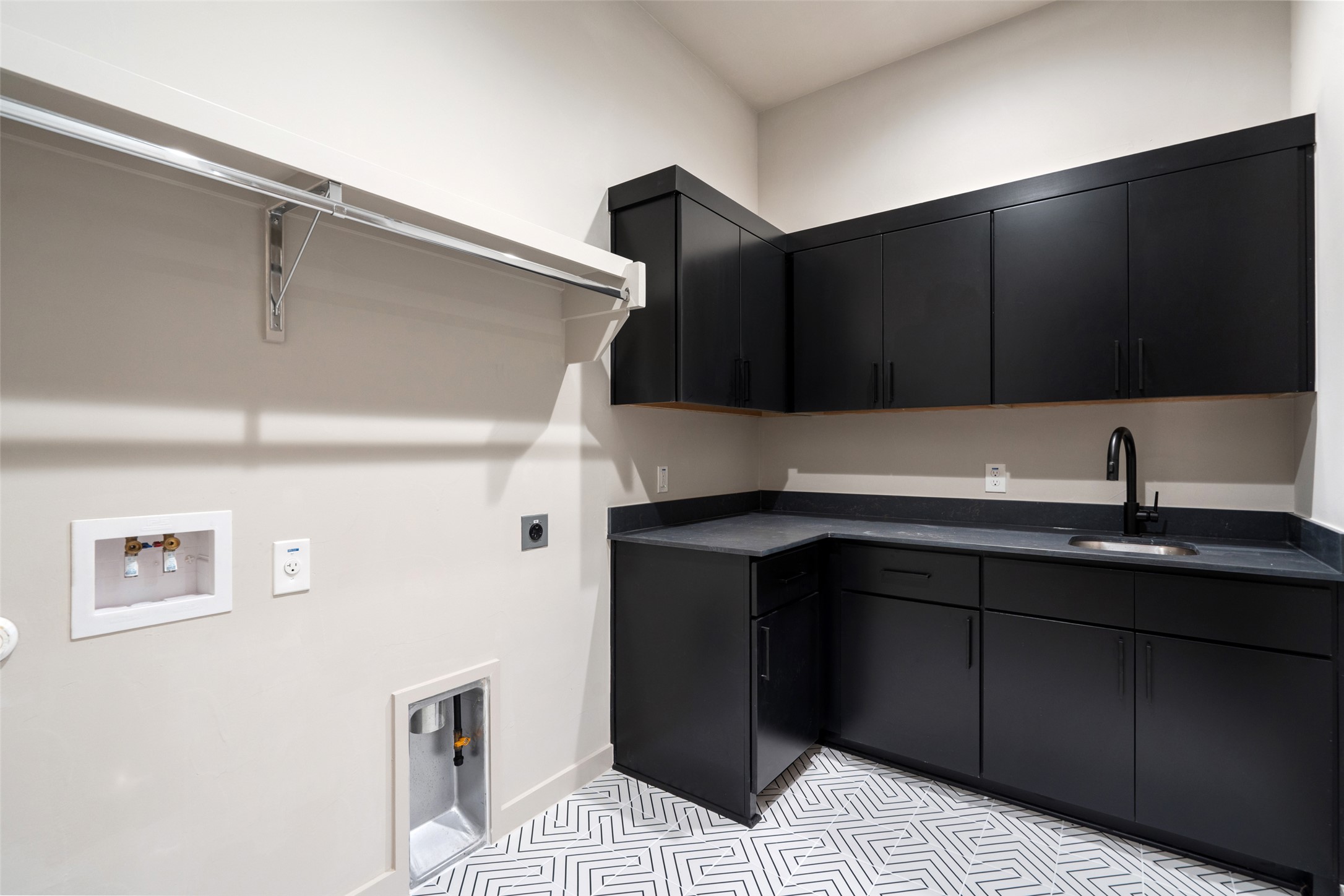 9803 Ribelin Ranch Court, Unit 6 Austin, TX 78750 - Photo 15 of 31 A dedicated laundry room features functional storage, a sink, and stylish patterned tile flooring.