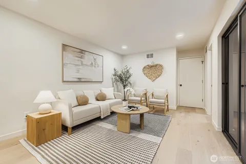 a living room with furniture and a potted plant