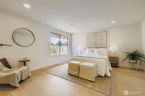 a bedroom with a bed and a large window