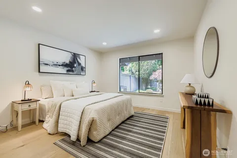 a bedroom with a bed and a painting on the wall