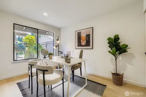 a view of a dining room with furniture and a window