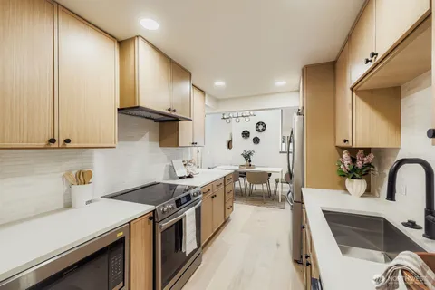 a kitchen with a sink and chairs