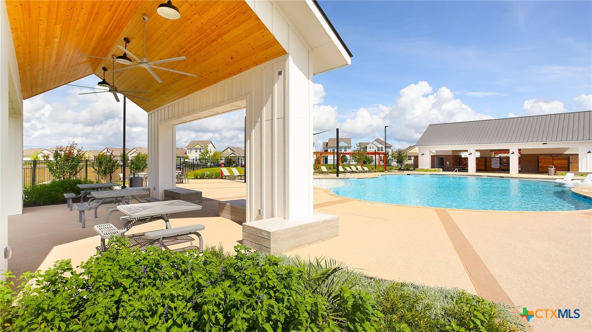 2971 Winding Creek Road Kyle, TX 78640 - Photo 8 of 16 a view of a swimming pool with a patio