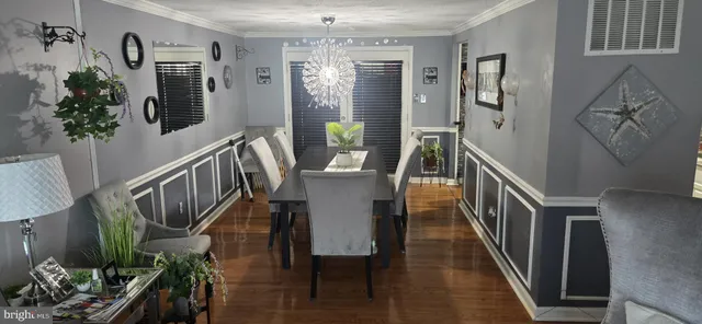 a view of a hallway with furniture and wooden floor