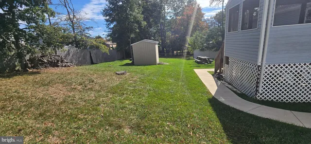 a view of a backyard with wooden fence