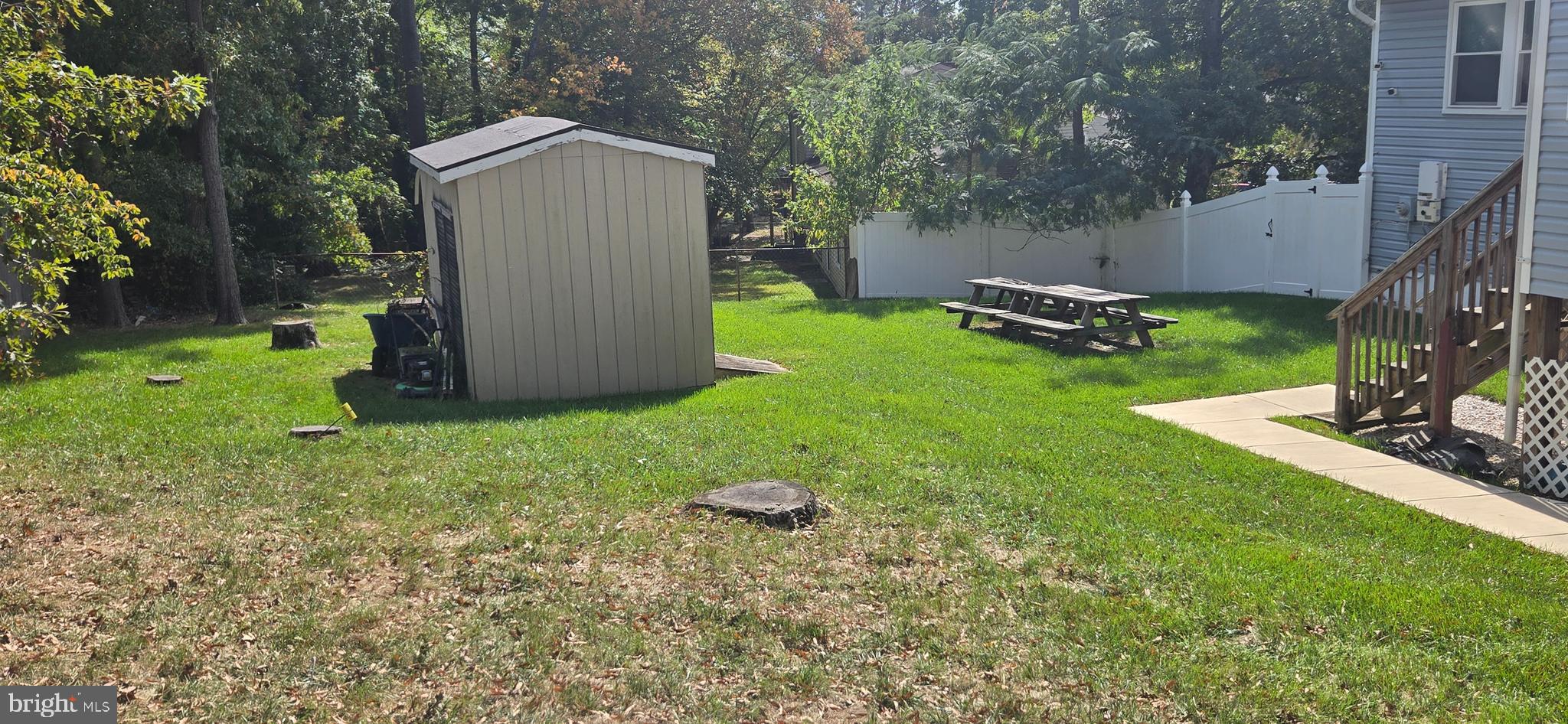 6311 Teaberry Way Clinton, MD 20735 - Photo 8 of 9 a backyard of a house with plants and outdoor seating