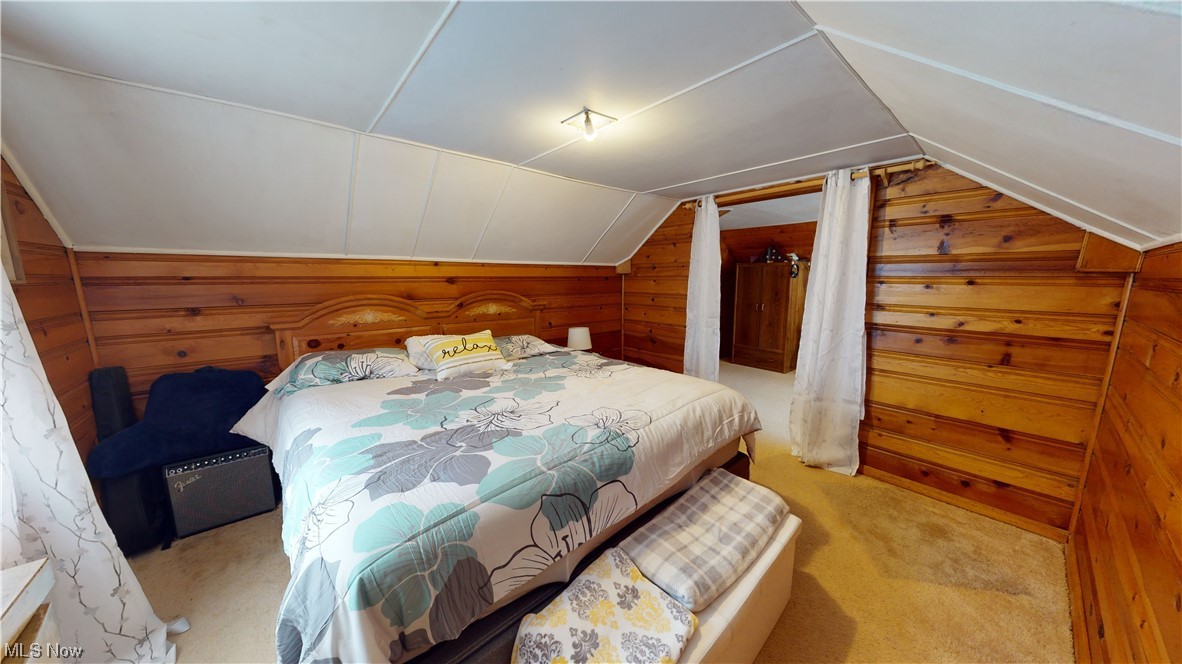 1331 Churchill Road Lyndhurst, OH 44124 - Photo 25 of 35 Bedroom featuring lofted ceiling, light colored carpet, and wood walls