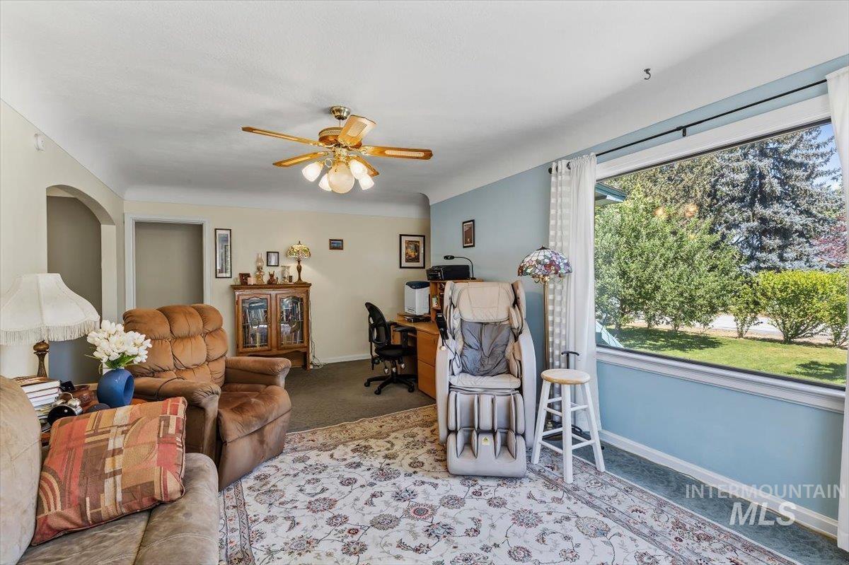 4619 Freemont Street Boise, ID 83706 - Photo 4 of 27 Spacious interior featuring a large picture window, a classic ceiling fan, and an arched doorway