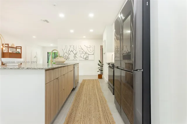 a view of a kitchen with a sink and refrigerator