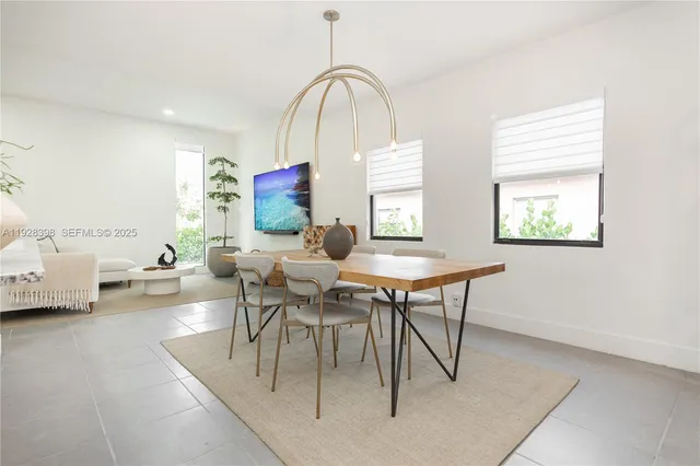 a living room with furniture a window and a table