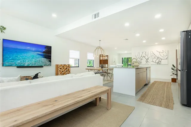 a bathroom with a sink a large mirror and a bathtub