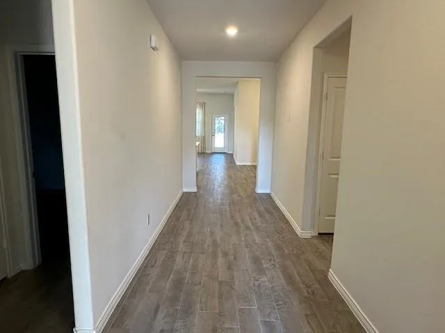a view of a hallway with wooden floor