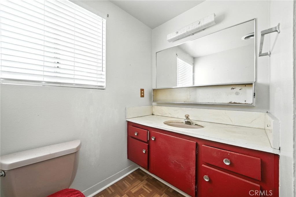 19717 Alonda Drive Carson, CA 90746 - Photo 20 of 31 a bathroom with a sink a toilet and a mirror