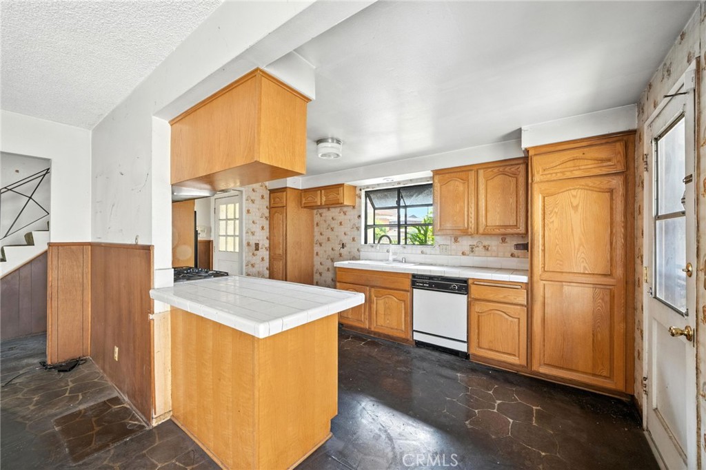 19717 Alonda Drive Carson, CA 90746 - Photo 8 of 31 a kitchen with granite countertop appliances a sink and a large window