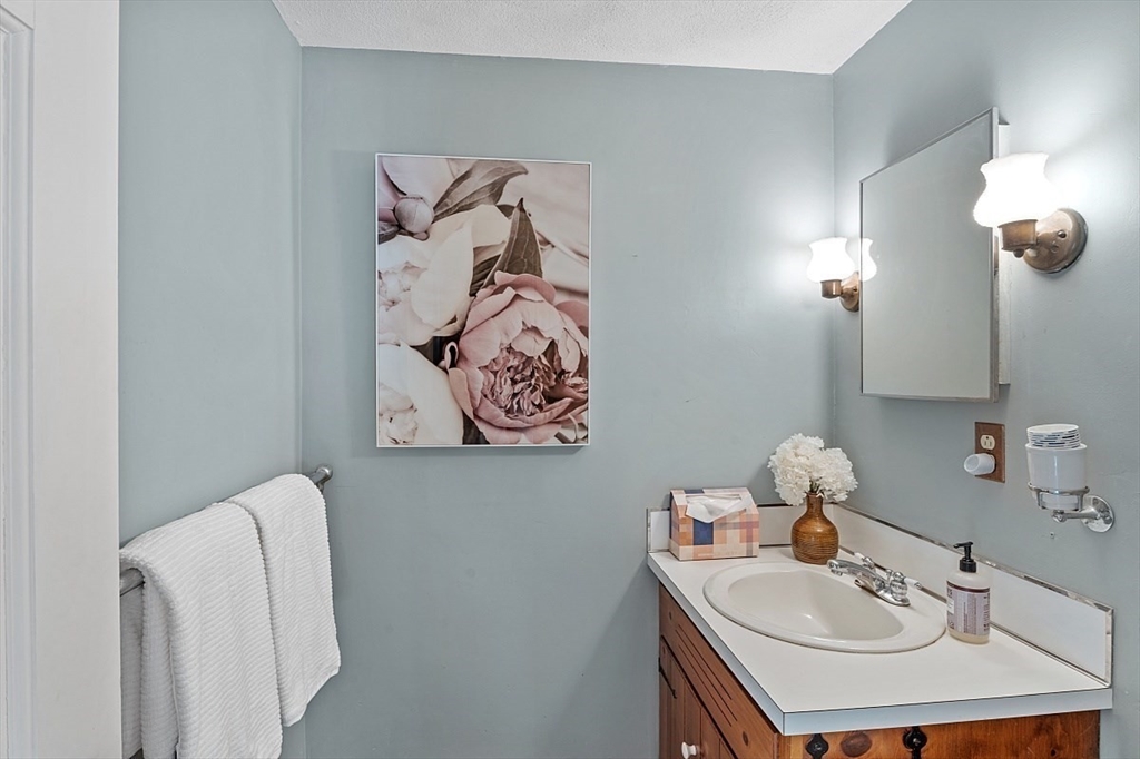 8 Honeysuckle Road Hamilton, MA 01982 - Photo 18 of 41 a bathroom with a sink and a mirror