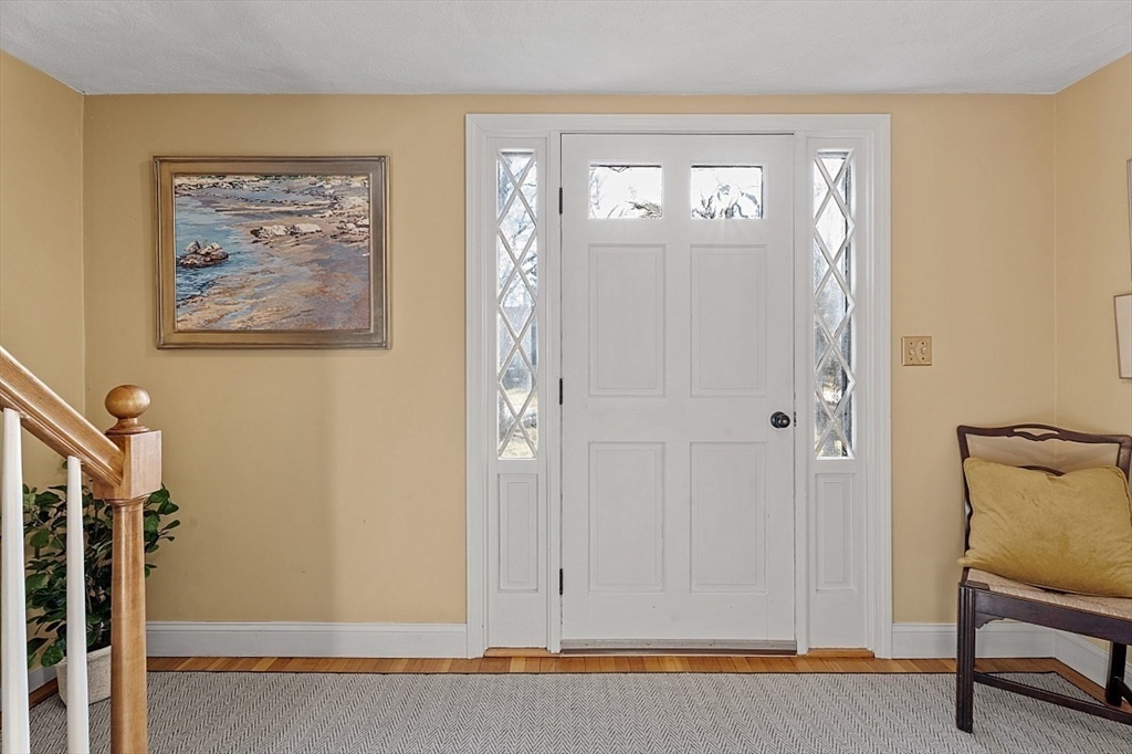 8 Honeysuckle Road Hamilton, MA 01982 - Photo 20 of 41 a view of a hallway with paintings on the wall