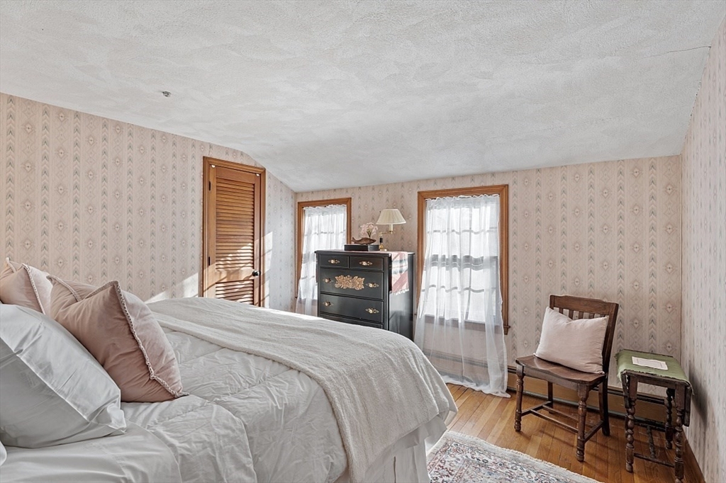 8 Honeysuckle Road Hamilton, MA 01982 - Photo 21 of 41 a bedroom with a large bed and a chair