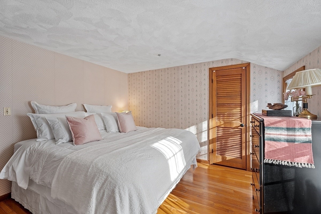 8 Honeysuckle Road Hamilton, MA 01982 - Photo 22 of 41 a bedroom with a bed and wooden floor