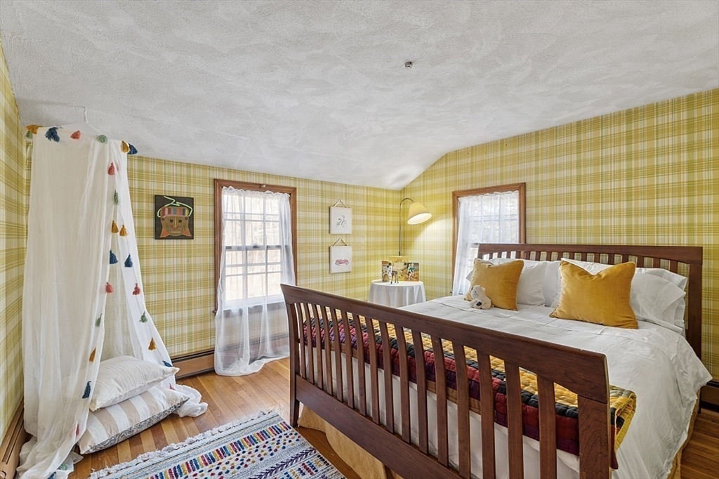 8 Honeysuckle Road Hamilton, MA 01982 - Photo 23 of 41 a bedroom with a bed and wooden floor