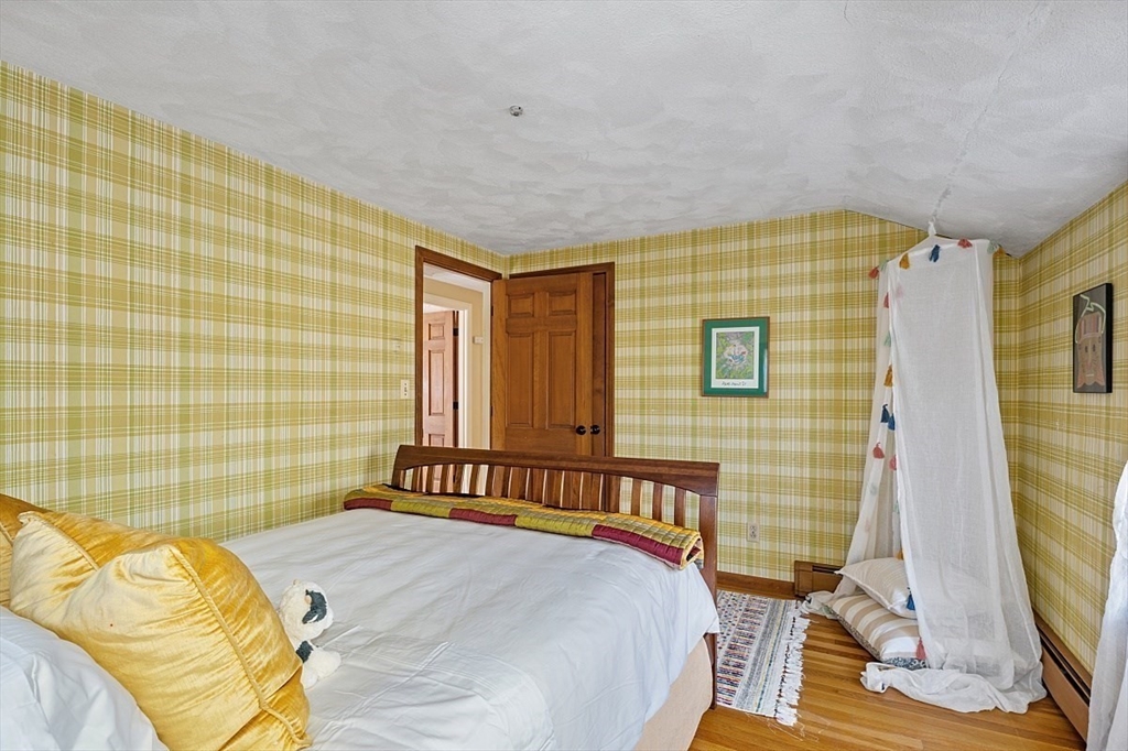 8 Honeysuckle Road Hamilton, MA 01982 - Photo 24 of 41 a bedroom with a bed and a flat screen tv