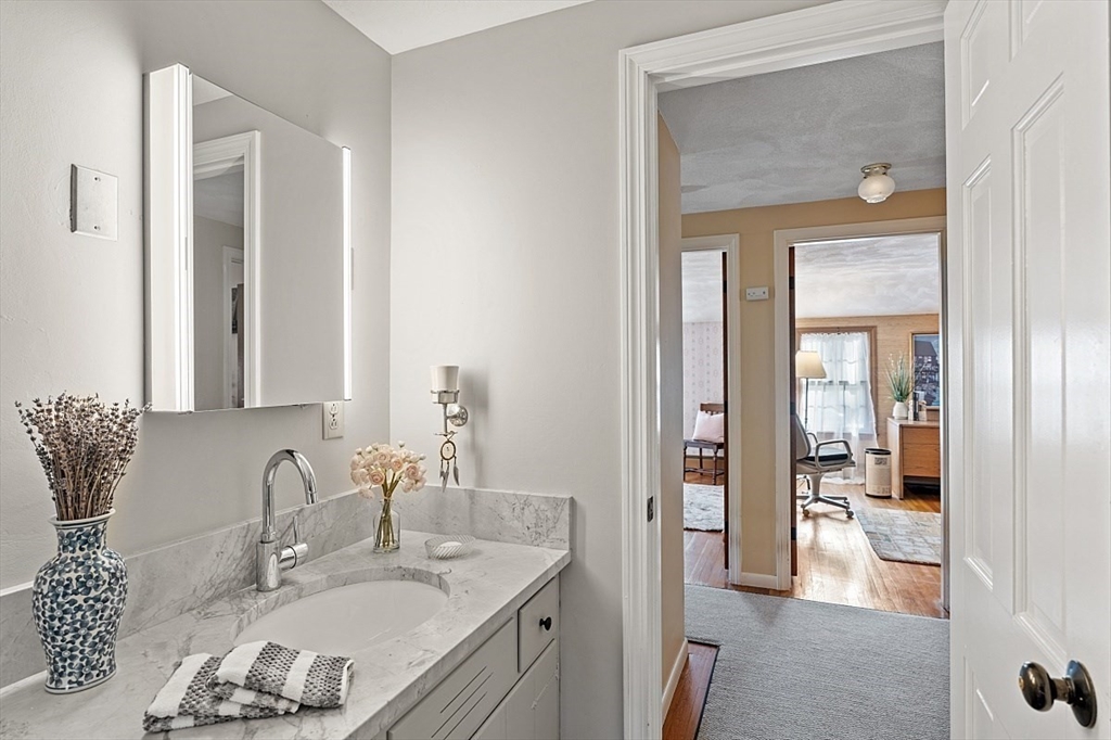 8 Honeysuckle Road Hamilton, MA 01982 - Photo 29 of 41 a en suite bathroom with a granite countertop sink and a mirror
