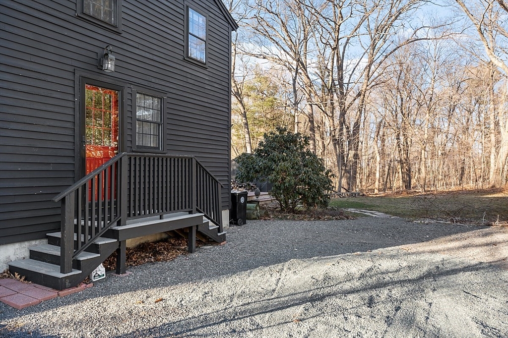 8 Honeysuckle Road Hamilton, MA 01982 - Photo 35 of 41 a view of backyard with wooden fence and a large tree