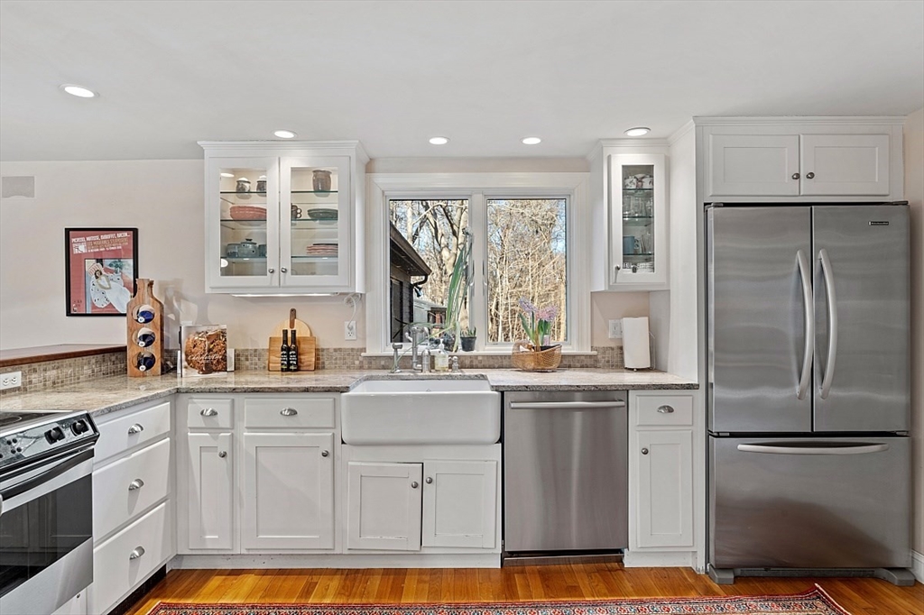 8 Honeysuckle Road Hamilton, MA 01982 - Photo 7 of 41 a kitchen with stainless steel appliances granite countertop a refrigerator sink and stove