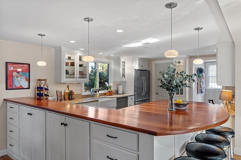 8 Honeysuckle Road Hamilton, MA 01982 - Photo 10 of 41 a kitchen with counter space sink and a chandelier